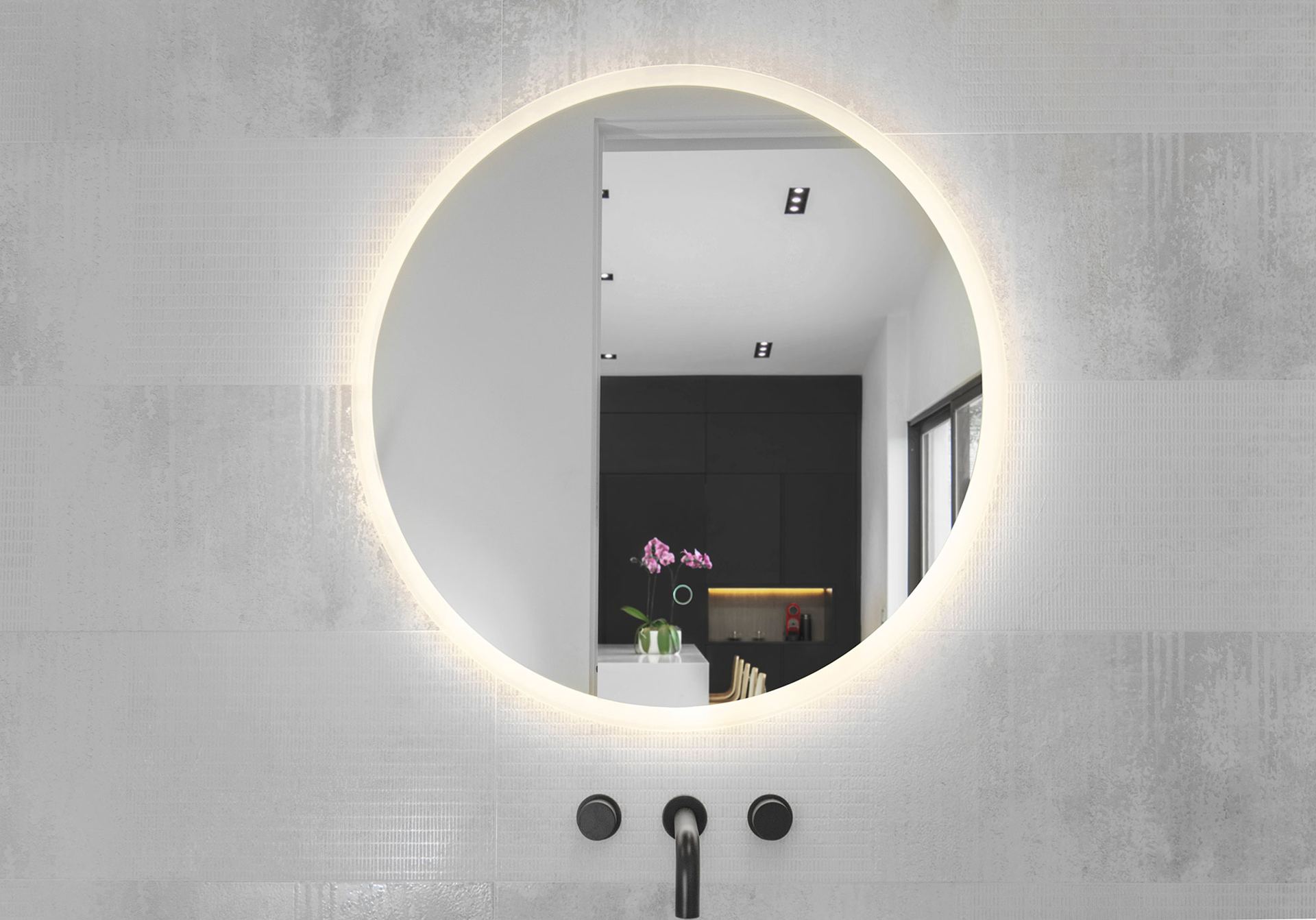 Minimalist bathroom with backlit round mirror