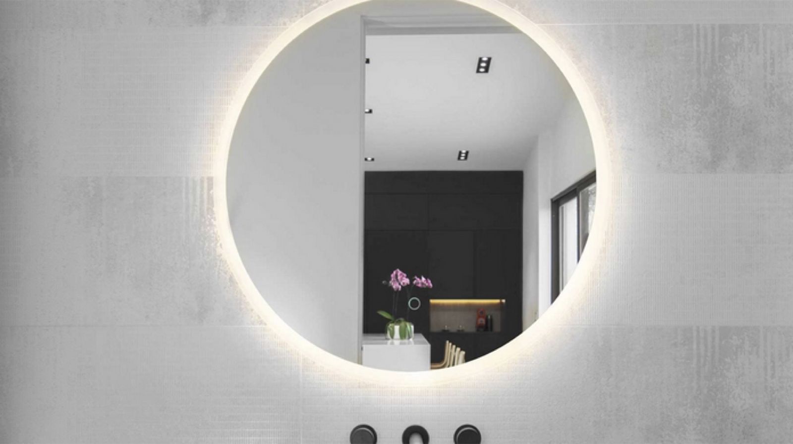 Minimalist bathroom with backlit round mirror